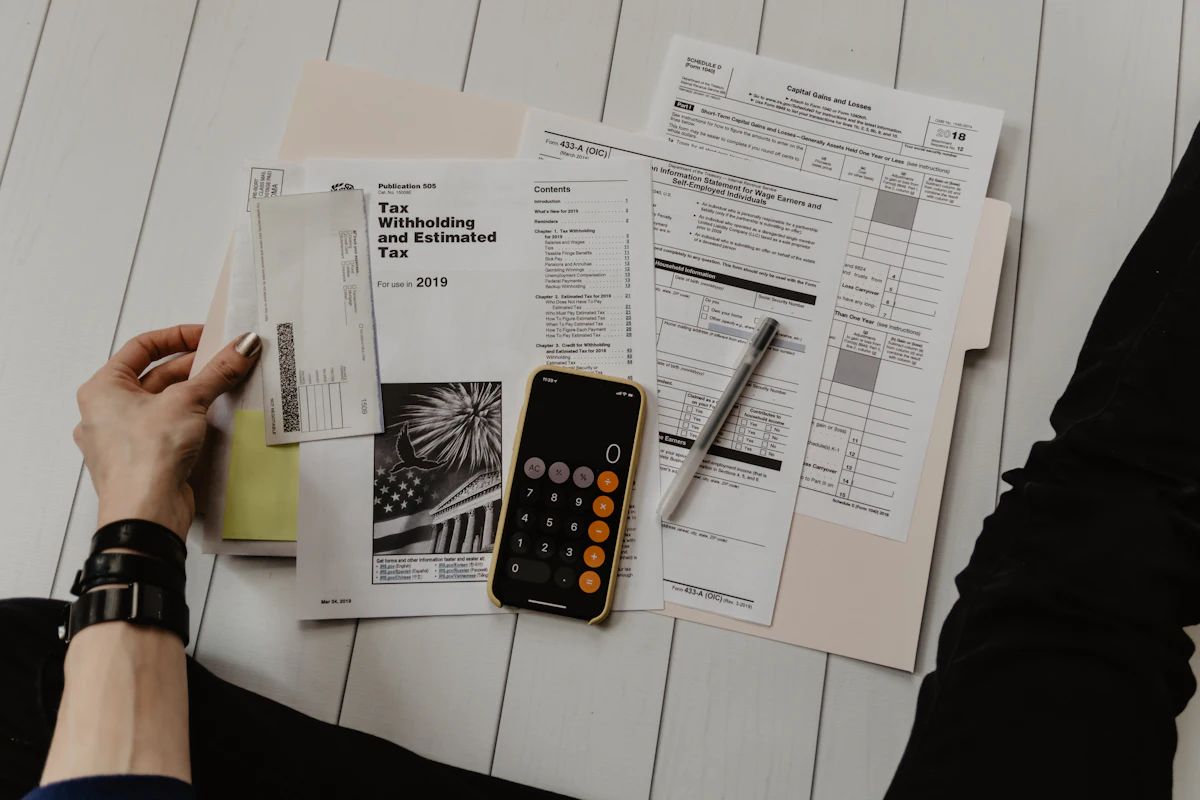 A calculator and paperwork used for budget planning